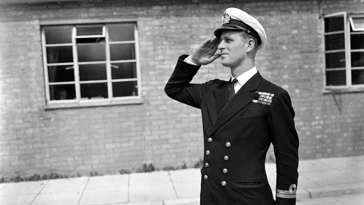 Lieutenant Philip Mountbatten saluting in Royal Naval uniform