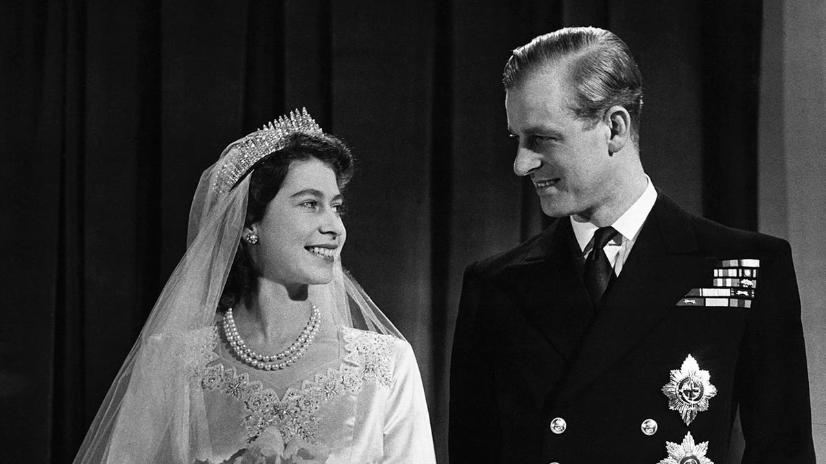 Princess Elizabeth and Phillip, Duke of Edinburgh, standing together on their wedding day.