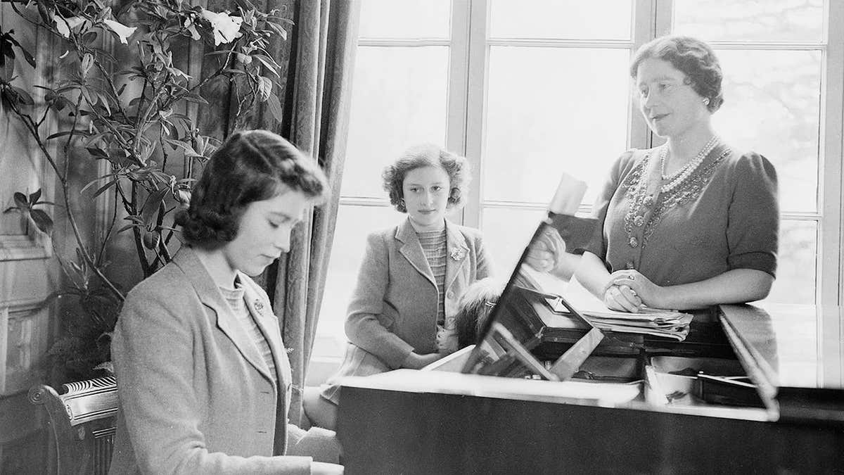 Princess Elizabeth playing piano with Queen Elizabeth and Princess Margaret watching at Royal Lodge Windsor Castle