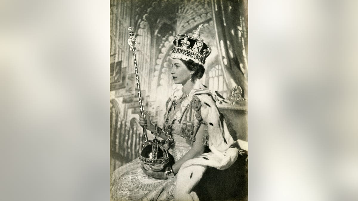 Queen Elizabeth II wearing the Imperial State Crown and holding the Sovereign's Orb and Sceptre