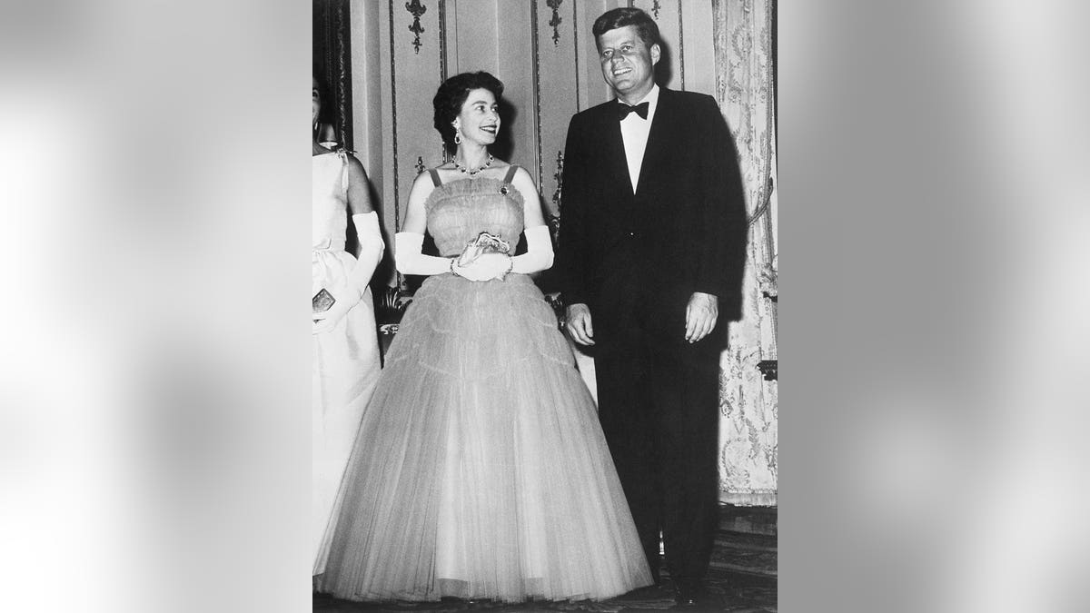 Queen Elizabeth smiling at President John F. Kennedy during a state dinner at Buckingham Palace