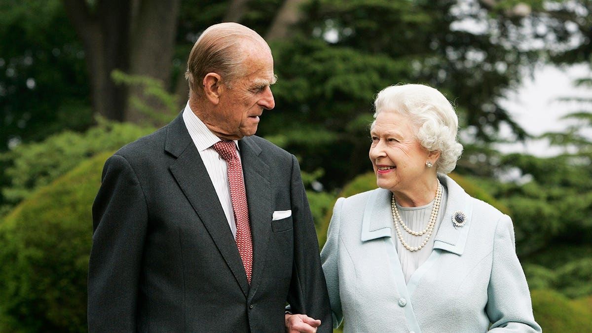 Queen Elizabeth II and Prince Philip standing outside Broadlands in Hampshire