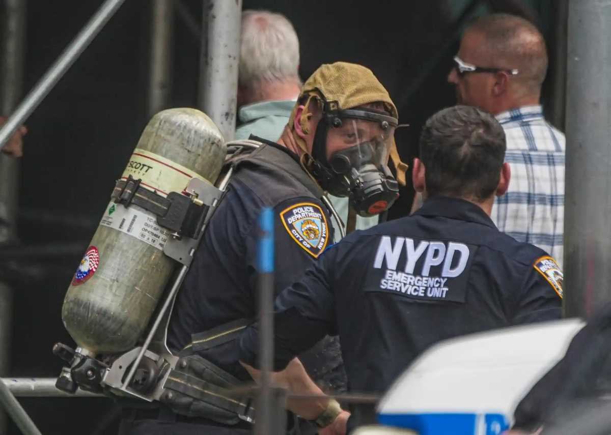 Police in protective gear helped remove the human remains of an adult man from a chimney at P.S./I.S. 113 on Tuesday, June 30.