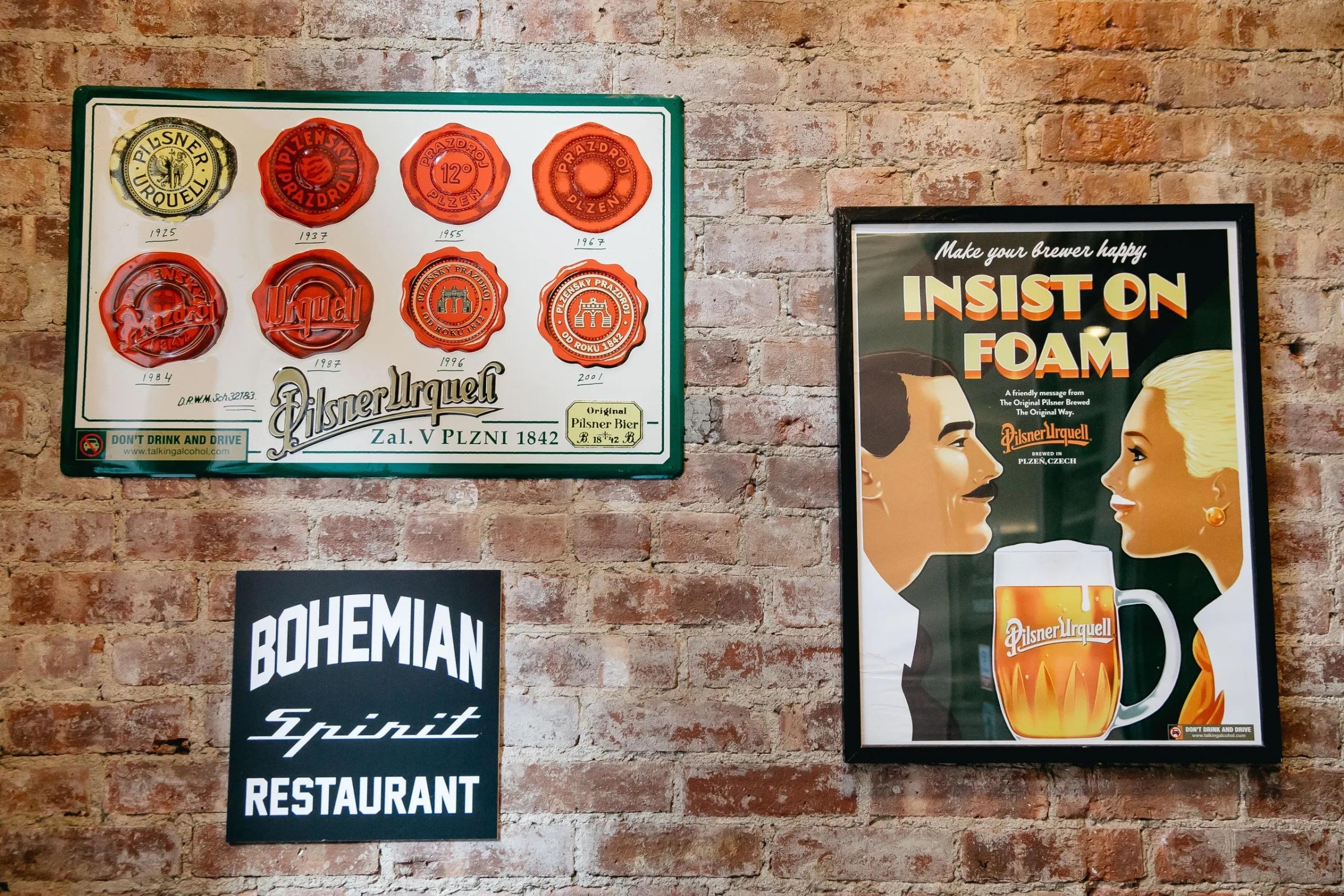 A brick wall with posters.