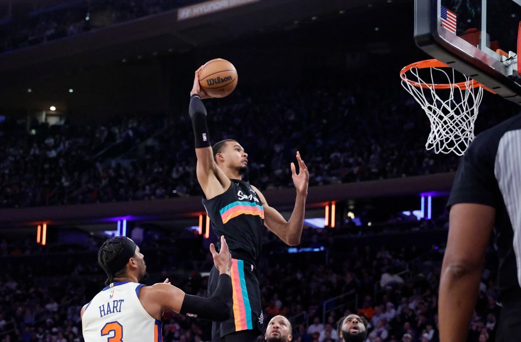 Victor Wembanyama of the San Antonio Spurs dunking a basketball during a game against the New York Knicks.