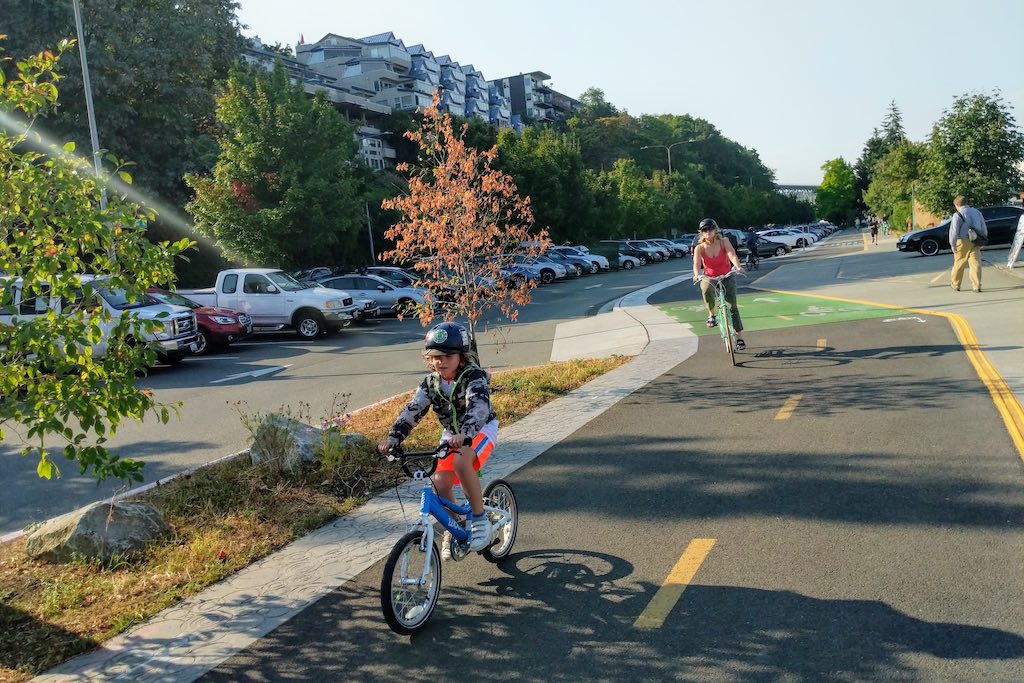 Two people cycling on a bike lane in Seattle, states