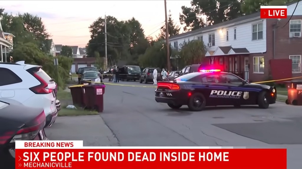A Mechanicville police car with flashing lights at a crime scene.