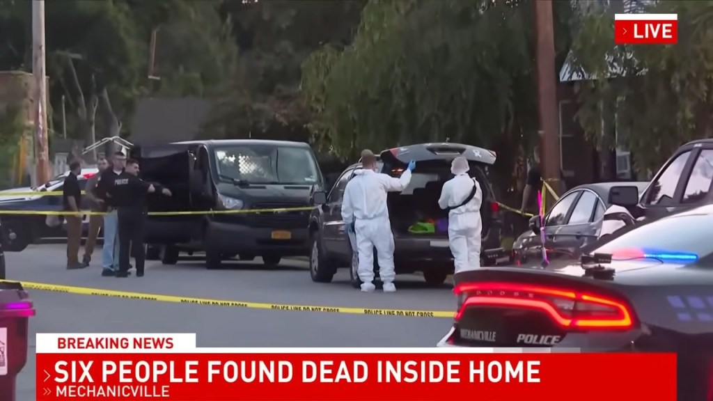 Police and forensic teams investigate a crime scene where six people were found dead in Mechanicville, New York.
