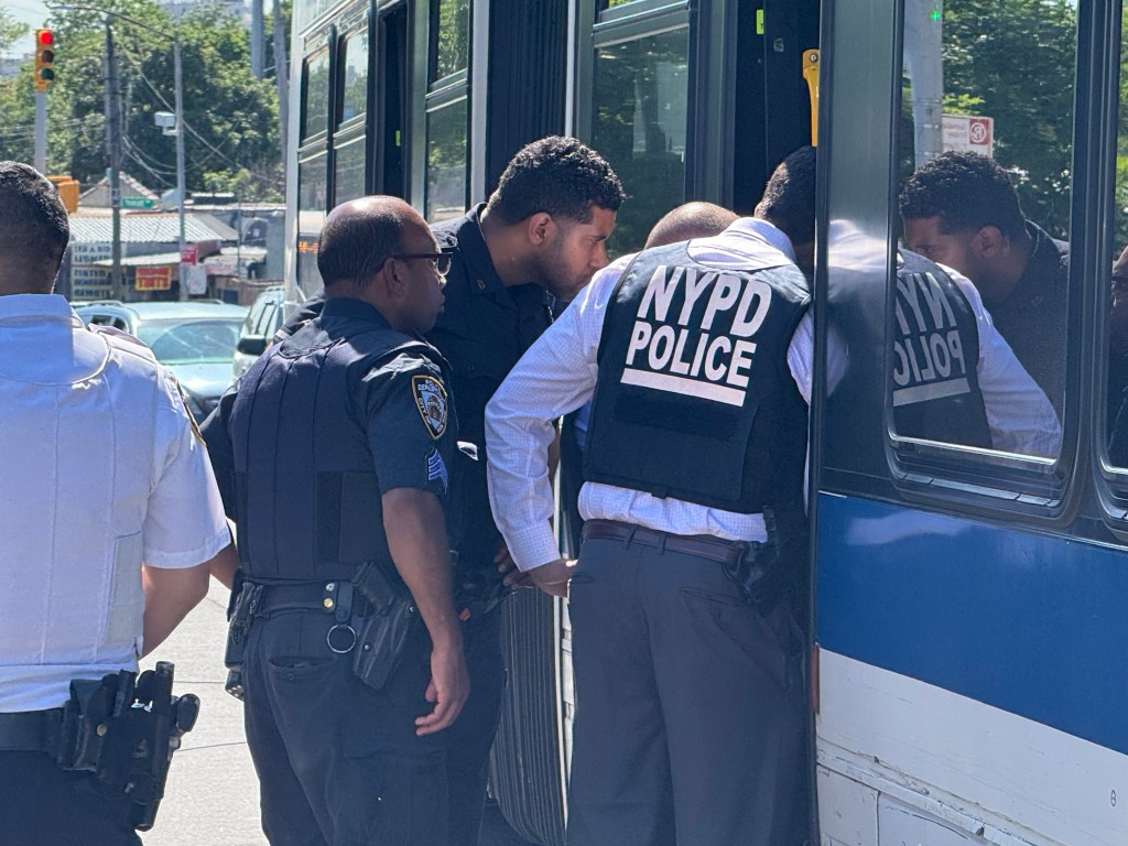 NYPD officers investigate a fatal shooting on an MTA bus.