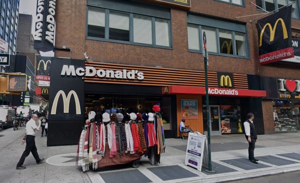 Exterior of a McDonald's restaurant in New York City with a street vendor selling scarves outside.