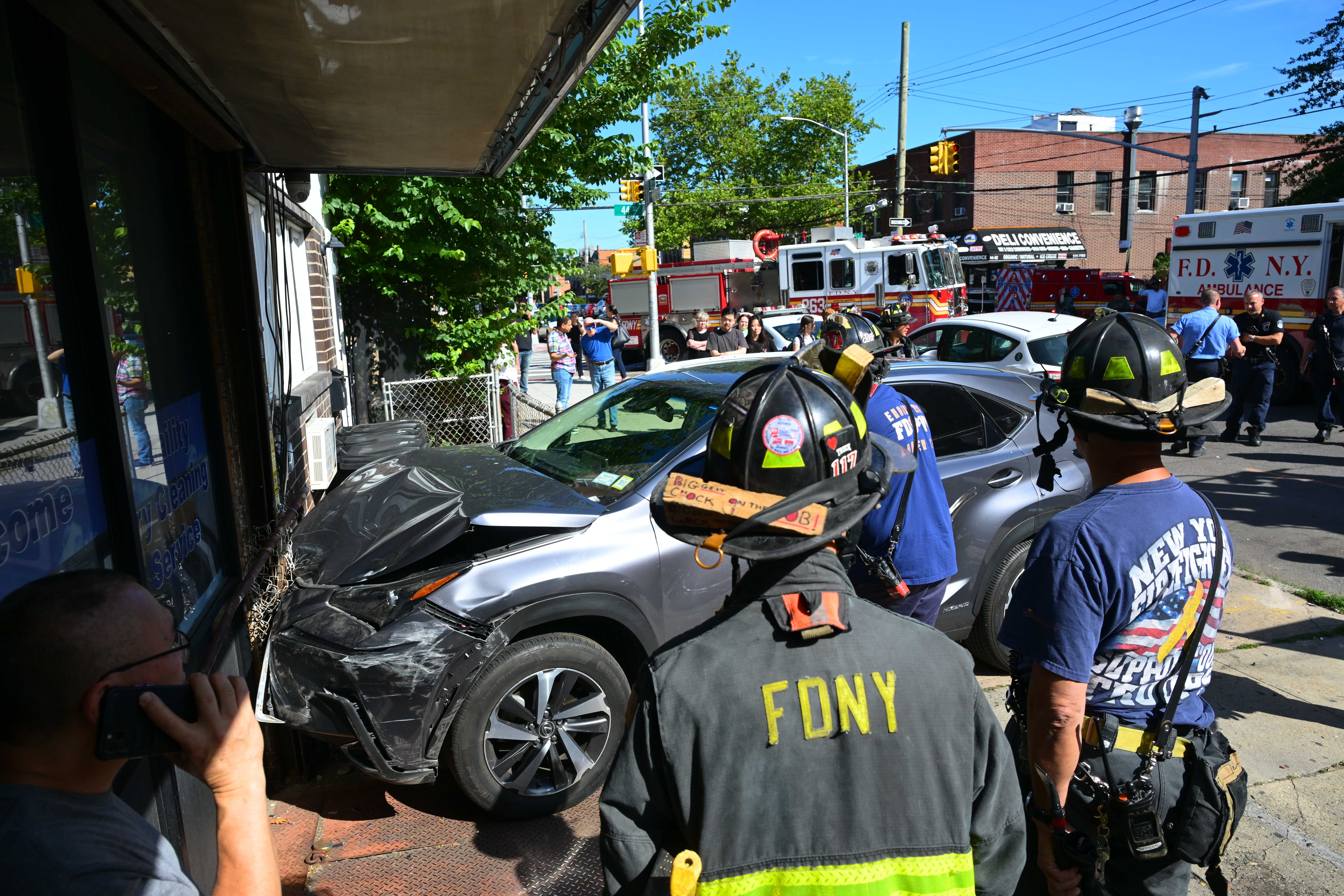 The Lexus SUV crashed into the exterior wall of a laundromat at 43-17 28th Avenue after slamming into a Citi Bike station in front of the building. 