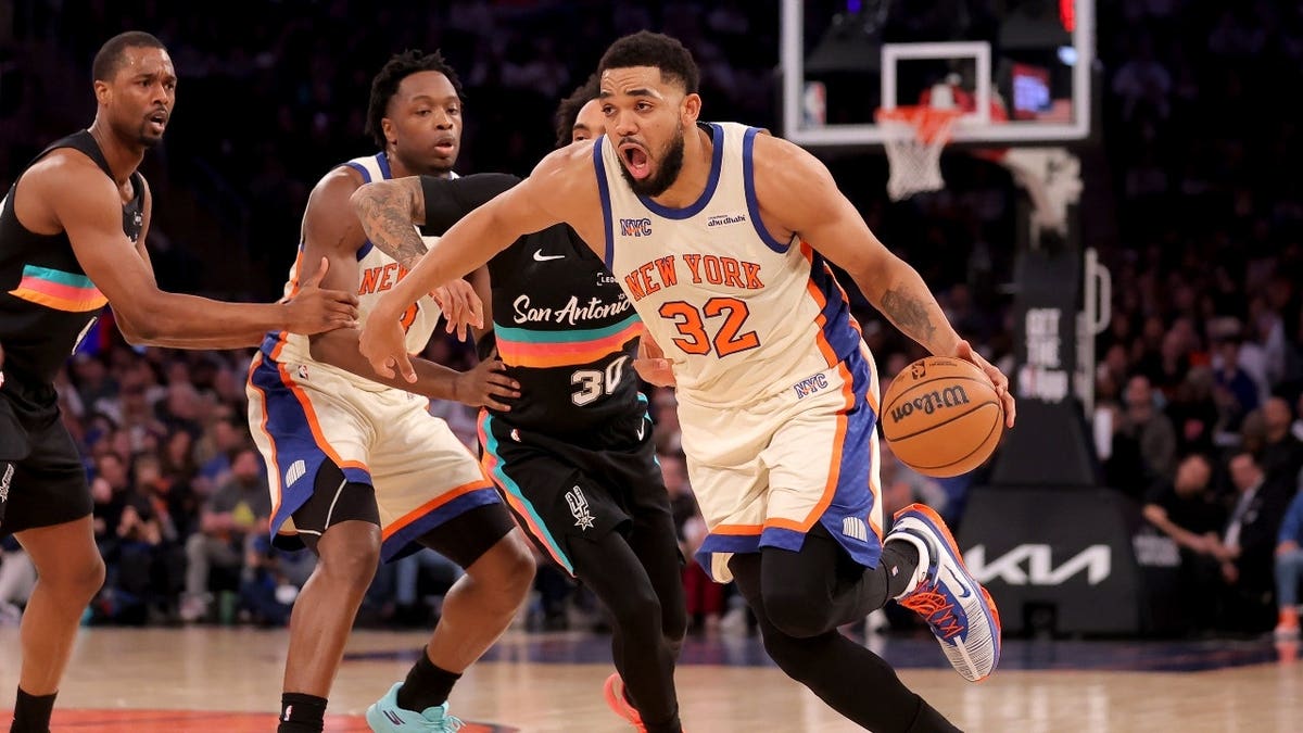 New York Knicks C Karl-Anthony Towns drives to the basket on San Antonio Spurs wing Julian Champagnie at Madison Square Garden.
