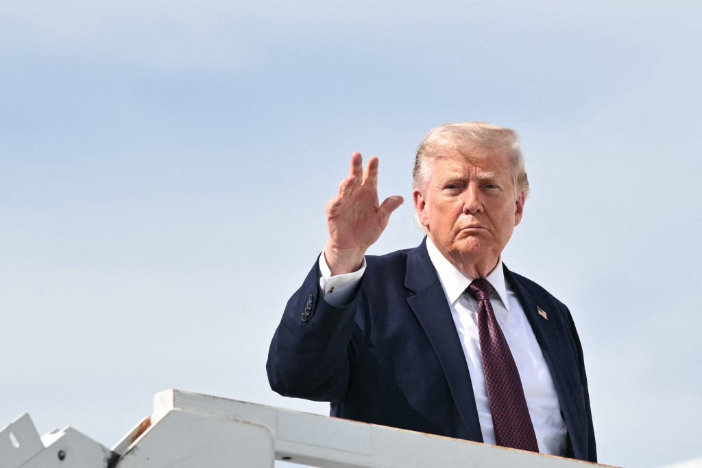US President Donald Trump waves as he boards Air Force One.