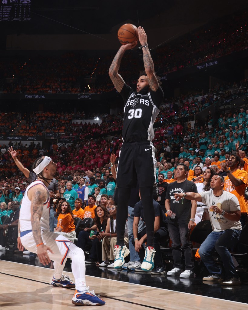 Julian Champagnie #30 of the San Antonio Spurs shoots a three-point basket during the game against the New York Knicks.