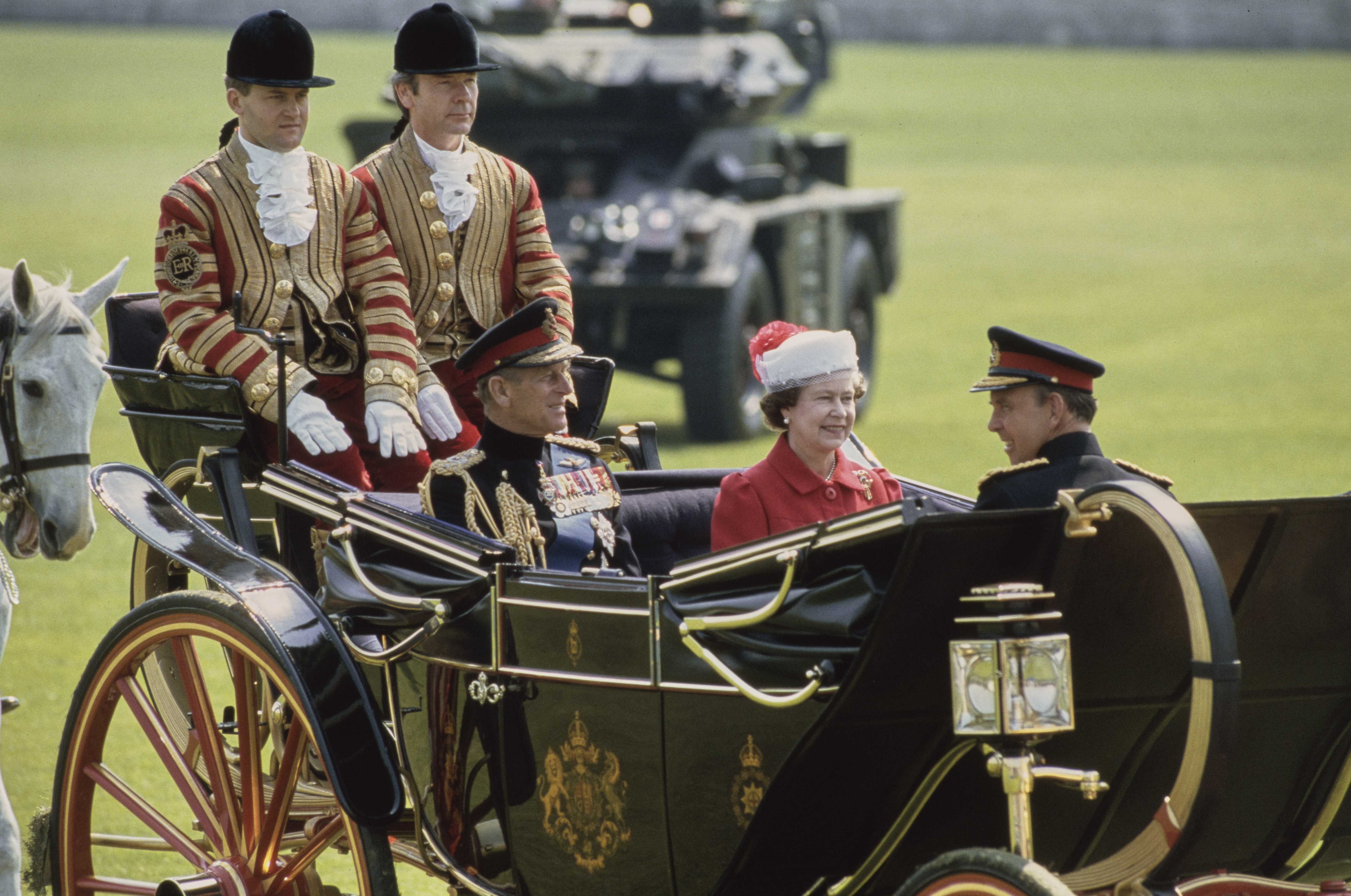 Queen Elizabeth riding in a carriage with Prince Philip and Paul Burrell riding in the back
