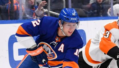 Jan 17, 2022; Elmont, New York, USA;  New York Islanders right wing Josh Bailey (12) looks to pass from behind the net defended by Philadelphia Flyers defenseman Keith Yandle (3) during the second period at UBS Arena. Mandatory Credit: Dennis Schneidler-USA TODAY Sports
