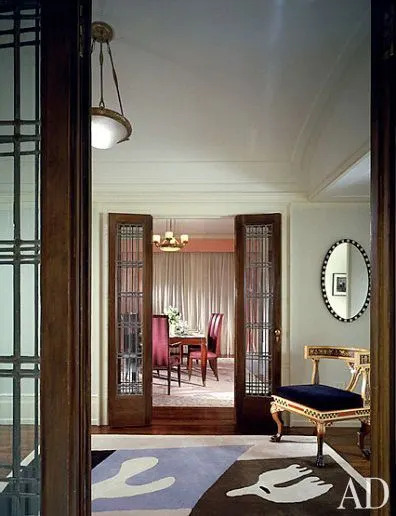 Ciccone, who converted three small apartments into one, kept the original circa-1915 leaded-glass doors. Above a second Klismos chair in the vestibule is a circa-1790 Irish cobalt-blue-and-white mirror. The circa-1924 gilt-bronze Süe et Mare chandelier has a bowl signed by Daum. Rug by Edward Fields.