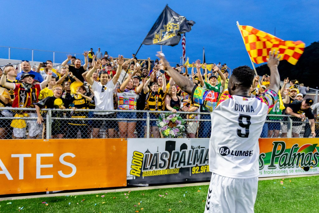 Albert Dikwa celebrates with fans in the Supporters' Section after the Pittsburgh Riverhounds' 1-0 win over Indy Eleven on June 13, 2026 at F.N.B. Stadium in Pittsburgh. (Photo: Chris Cowger/Riverhounds SC)