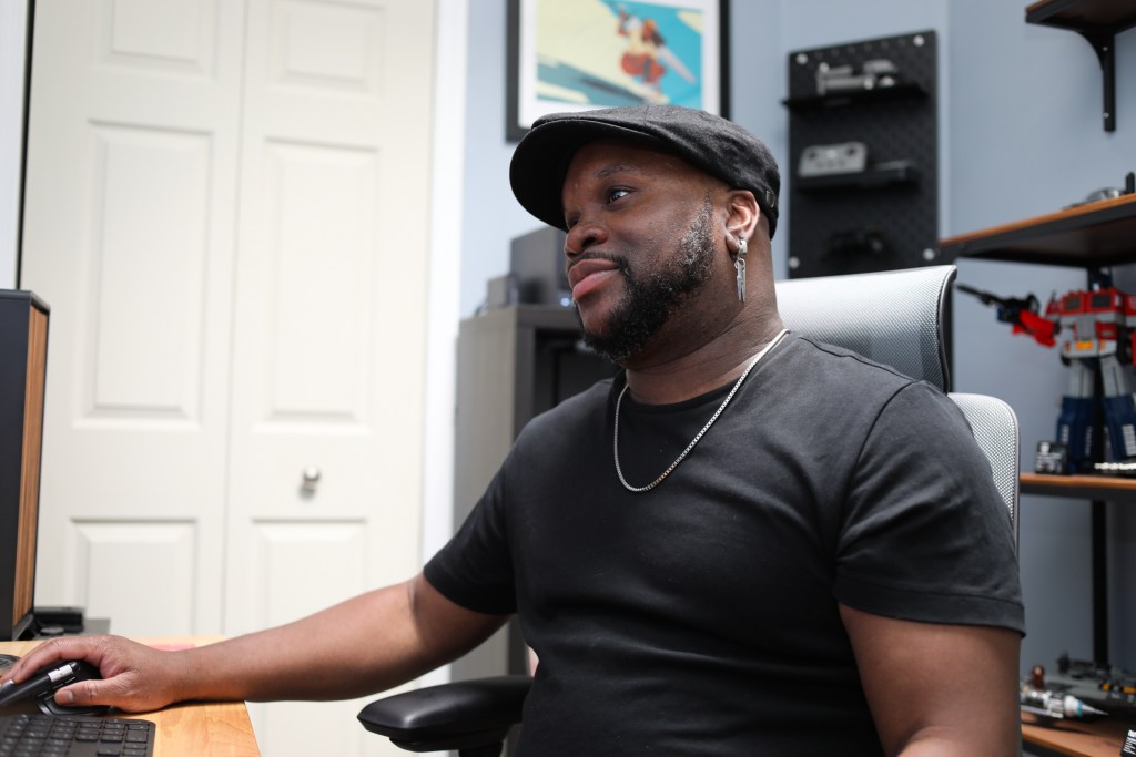 Animator Brandon V. Fletcher sits at his computer in his Bed-Stuy apartment.