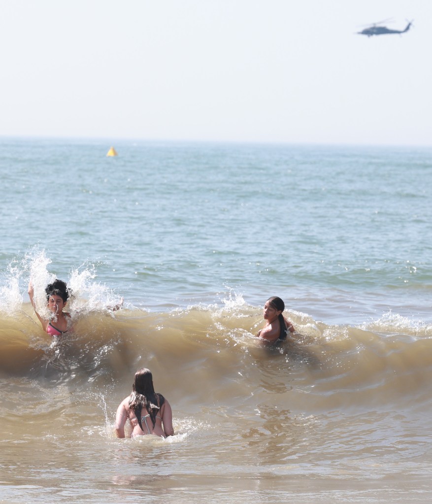 Spectators cool off in the Atlantic Ocean during practice for the FourLeaf Air Show.