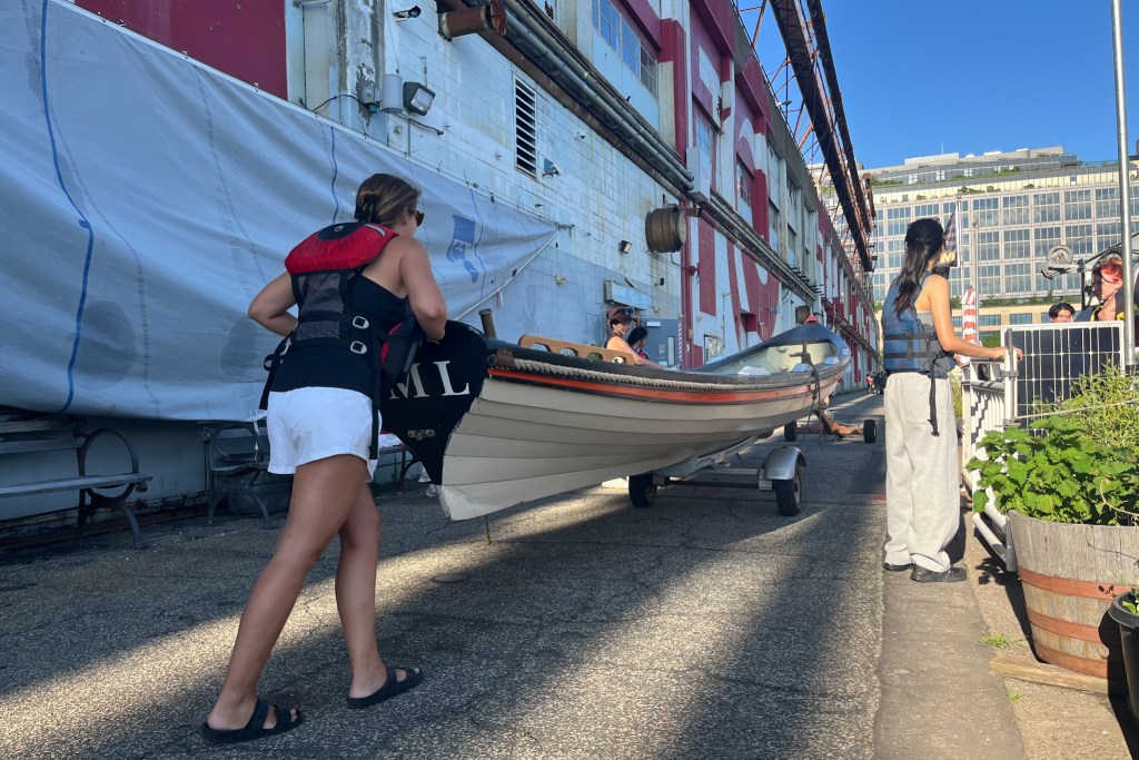 Members of the Village Community Boathouse take homemade vessels onto the Hudson River,