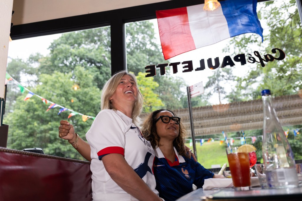 Cafe Paulette owner Angelique M. Rufty-Graux, left, watches France play Morocco in the World Cup quarterfinals