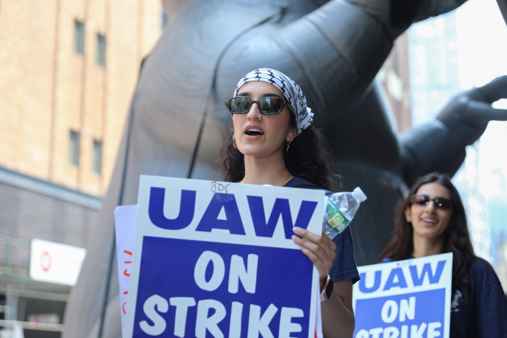 Brooklyn Defender Services workers unionized with the UAW walk a picket line on Livingston Street in front of their offices