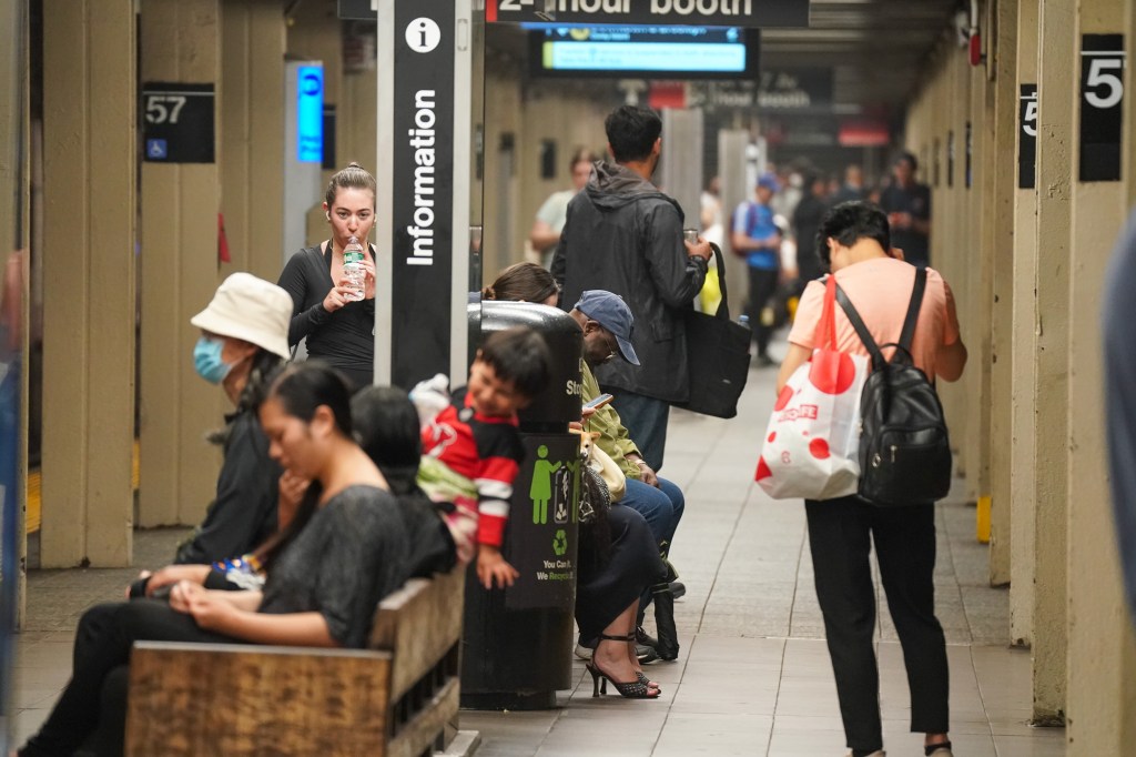 People waiting at a subway station platform.