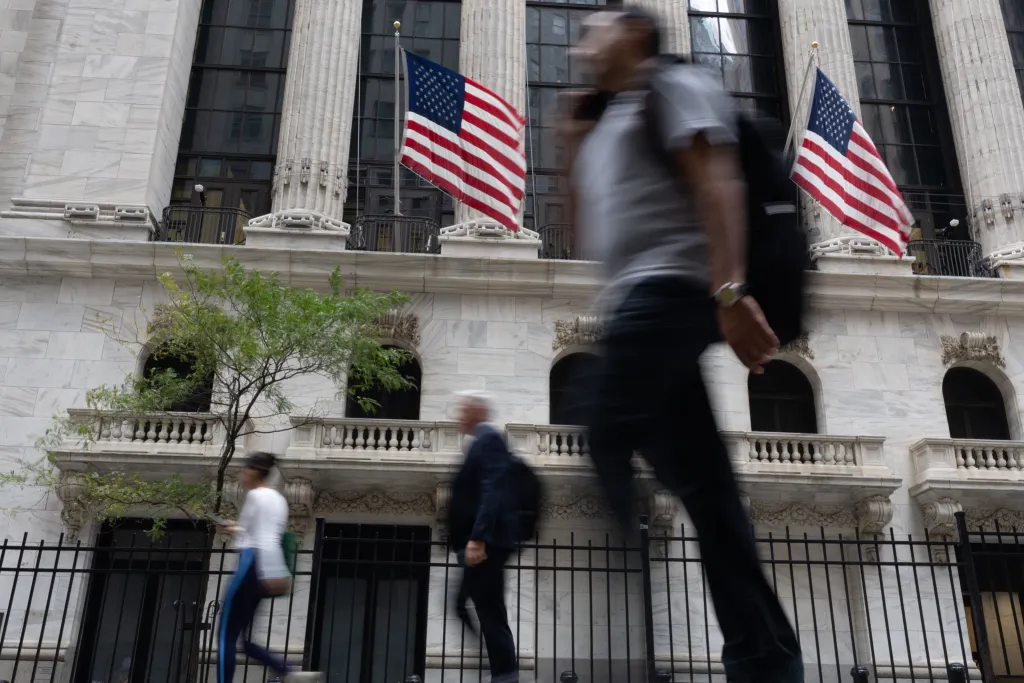 Professional workers walk near Wall Street in the Financial District