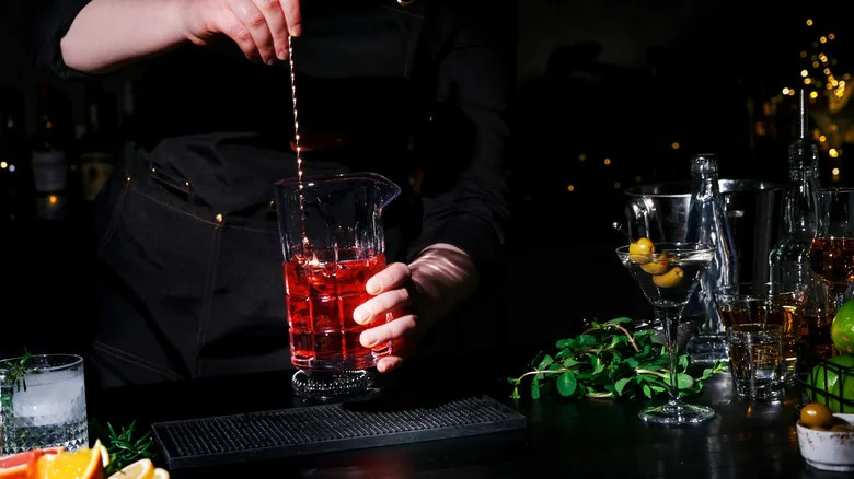 Bartender stirring a Manhattan cocktail