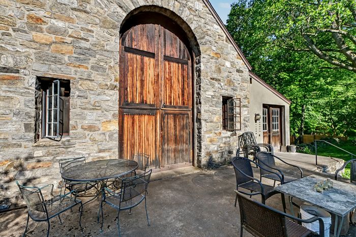 The terrace doubles as a spot for outdoor dining and looks over a lawn where Lucia Nebel White once kept a garden.