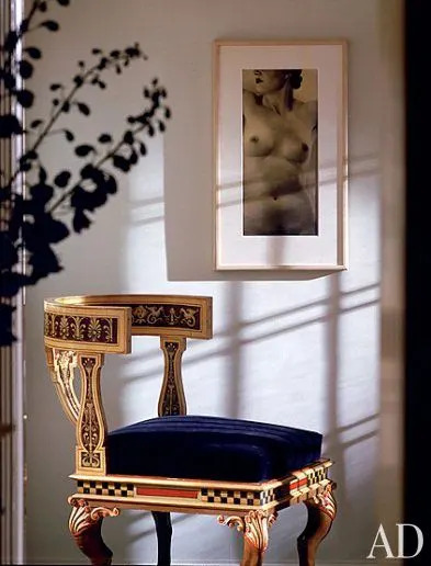 Setting the muted tone in the entrance is a circa-1930 Fresson print titled Nude by French photographer Laure Albin-Guillot and a Pompeian-style Klismos chair from the late 19th century.