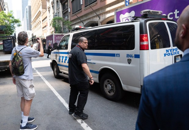 The couple who climbed to the top spire on the Empire State Building are driven away from the building after being arrested Wednesday, July 1, 2026 in Manhattan, New York. (Barry Williams/ New York Daily News)