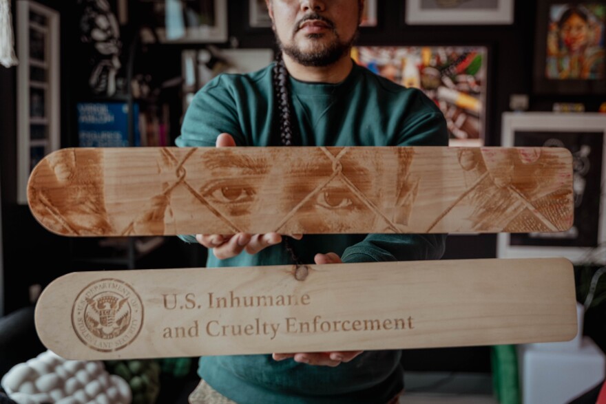 Victor "Marka27" Quiñonez holds portions of his sculpture from his "I.C.E. Scream" series in his studio.