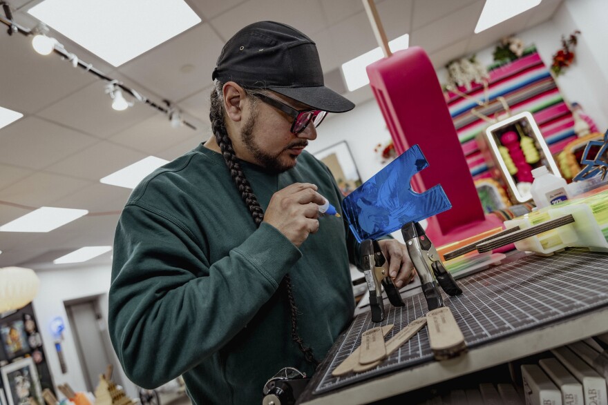 Victor "Marka27" Quiñonez's crafts the resin portion of paleta sculptures from his "I.C.E. Scream" series.