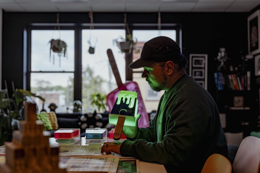 Victor "Marka27" Quiñonez, Mexican-born, Brooklyn-based visual artist holds the acrylic sculpture "Drippy Paleta Lime / Uva flavor" from his "I.C.E. Scream" series at his studio in Ridgewood, Queens.