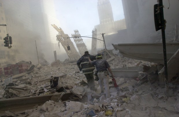 Firefighters walk through the rubble of the World Trade Center on Sep. 11, 2001. (Todd Maisel / New York Daily News)