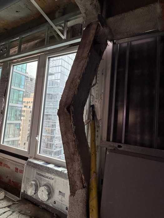 buckled steel beam inside Midtown building