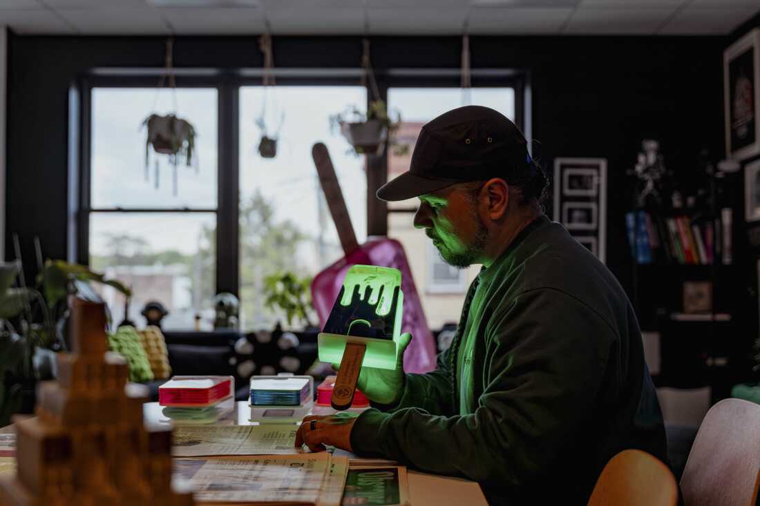 Victor "Marka27" Quiñonez, Mexican-born, Brooklyn-based visual artist holds the acrylic sculpture "Drippy Paleta Lime / Uva flavor" from the "I.C.E. Scream" Series at his studio in Ridgewood, Queens.