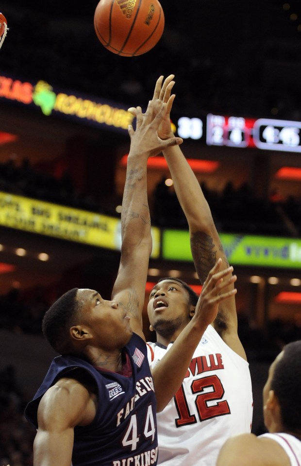 Fairleigh Dickinson's Kinu Rochford, left, during the first half of their NCAA college basketball game on Saturday, Dec. 10, 2011, in Louisville, Ky. (AP Photo/Timothy D. Easley)