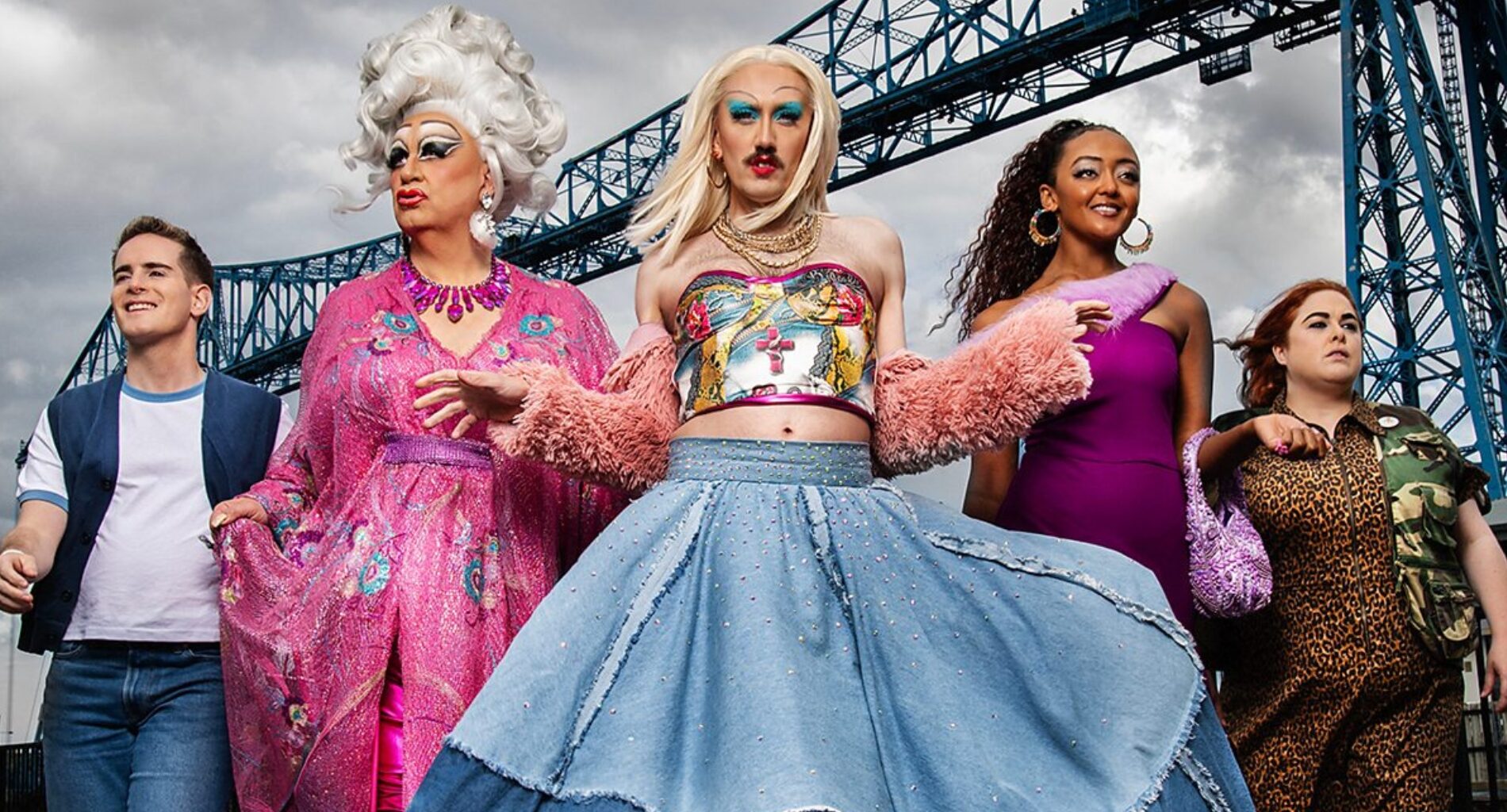 Smoggie Queens still, five individuals walking against a grey cloudy sky