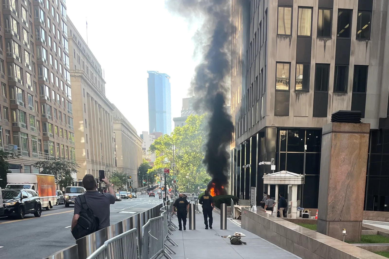 Black smoke and flames in front of 26 Federal Plaza in lower Manhattan on July 20, 2026.