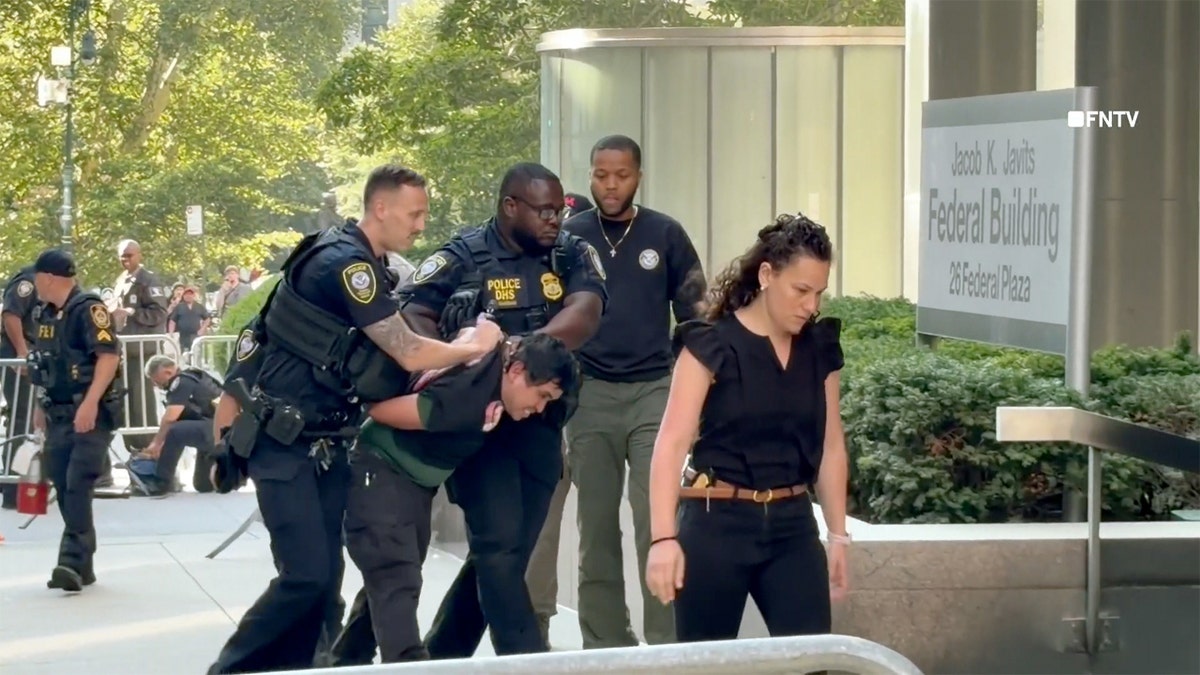 Authorities apprehend someone outside of a federal building in New York City