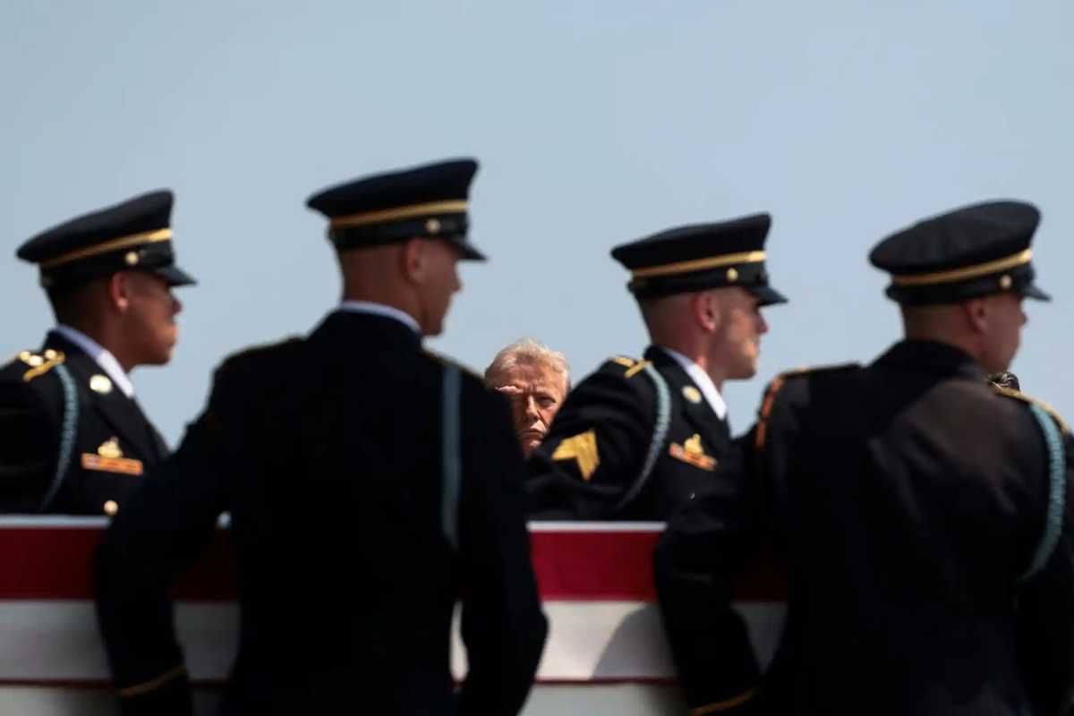 President Donald Trump salutes as one of the four service members killed in action passes by during the dignified transfer at Dover Air Force Base in Delaware on Wednesday.
