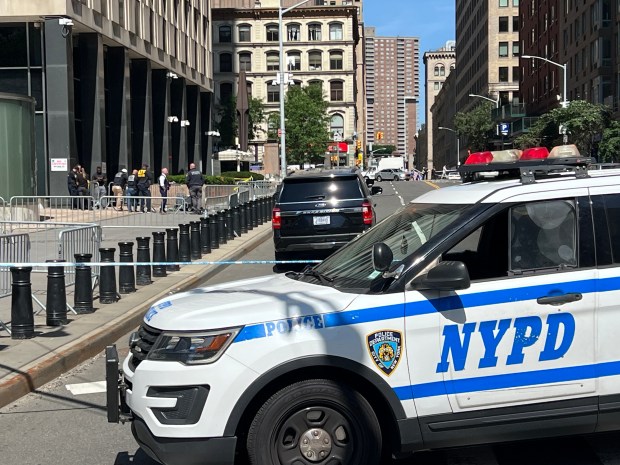 A suspect was taken into federal custody outside 26 Federal Plaza in Lower Manhattan Monday morning after setting off fireworks and menacing passersby with a gun, police sources said. (Barry Williams / New York Daily News)
