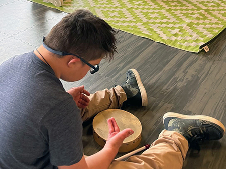 Music therapy client playing drums