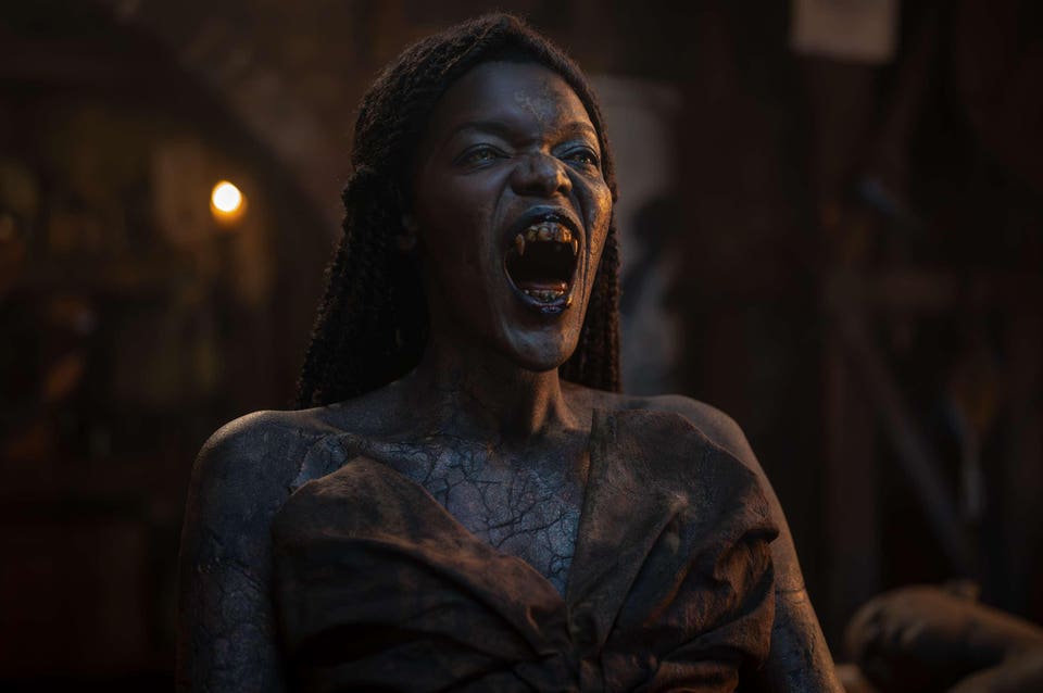 Akasha is awake. Her mouth is open and her fangs are dropped.