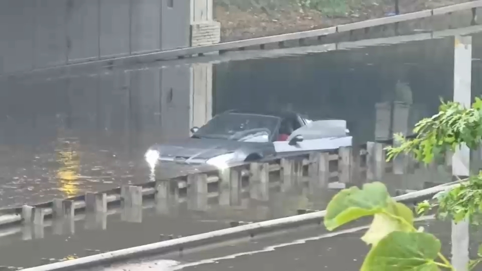 Drivers seen climbing out windows as floodwaters rise in Queens