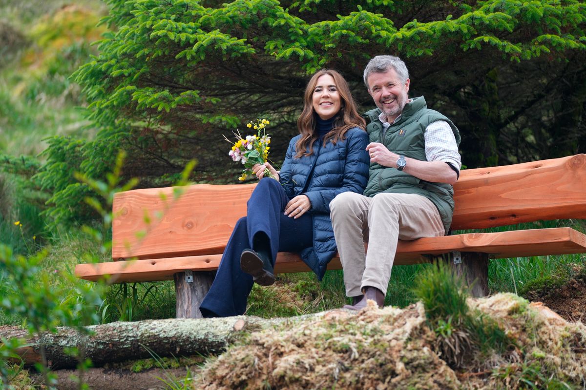 King Frederik X and Queen Mary sit on a bench after planting a tree in the plantation in Tvoeroyri on the island of Suduroy in the Faroe Islands, on June 12, 2025. 