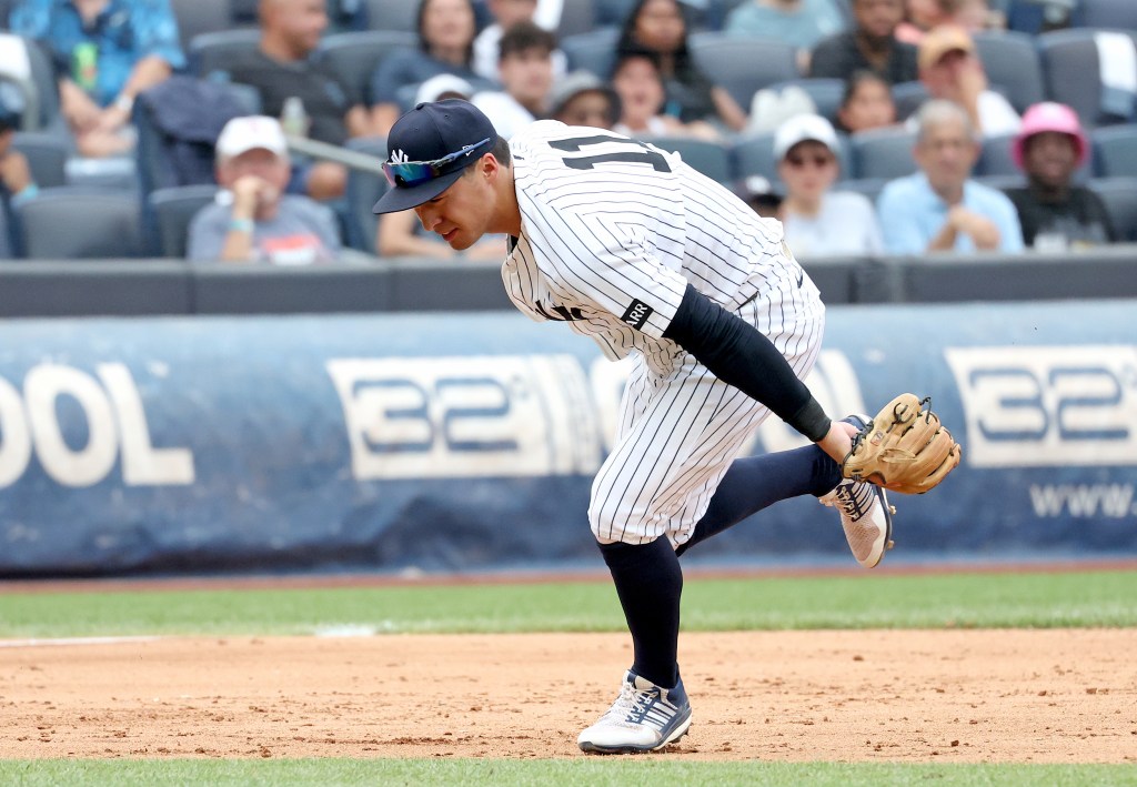 Yankees shortstop Anthony Volpe (11) makes a fielding error during the sixth inning when the New York Yankees played the Minnesota Twins